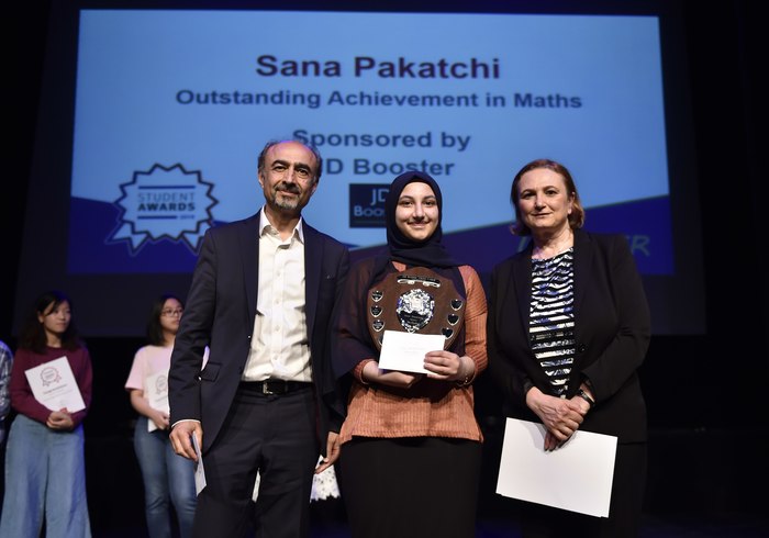 Winner Sana Pakatchi (in the middle) receiving the award, standing to the right is Parvaneh Alinaghian, Head of Maths Curriculum at the Harrow College.